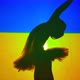 Side View Silhouette of Ballerina at Ukrainian Flag with Backlit Raising Hands Praying - VideoHive Item for Sale