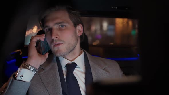 Handheld Businessman Sitting in a Moving Car Talking on a Mobile Phone and Using Laptop Man Top alt