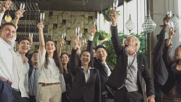 Group of business people toasting champagne to celebrate on New Year alt