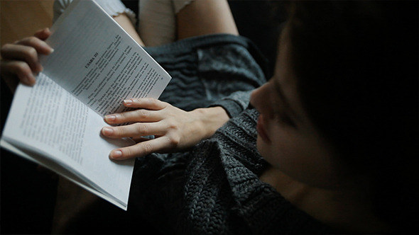 Young Beautiful Caucasian Woman Reading A Book