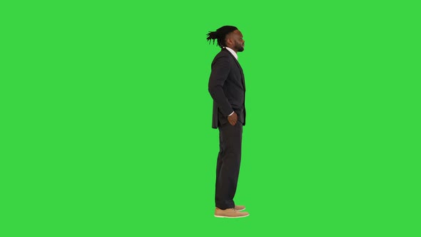 Black Man in Office Suit Having a Conversation on a Green Screen Chroma Key alt