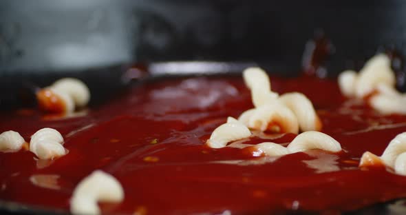 Boiled Pasta Cavatappi Fall Into Tomato Sauce alt