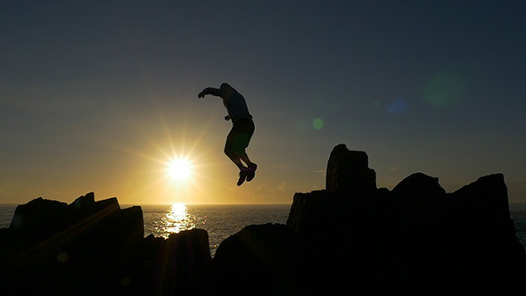 Jumping Across Rocks at Sunrise