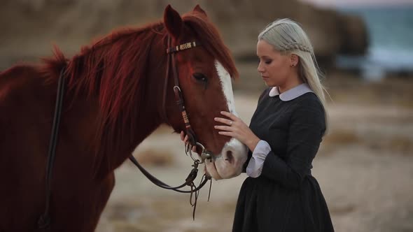 Beautiful Young Girl in Retro Style Dress Posing Near Horse