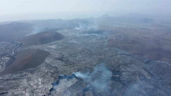 High Aerial View of Volcanic Lava Lake in Fagradalsfjall Drone Flies Backwards Towards Crater alt