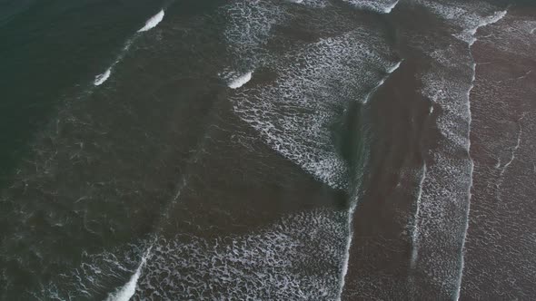 Top View Of Foamy Waves At Scarborough North Bay Beach In North Yorkshire, England UK. Aerial Shot alt