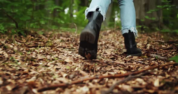 Backview of Female Hiking Boots in Forest