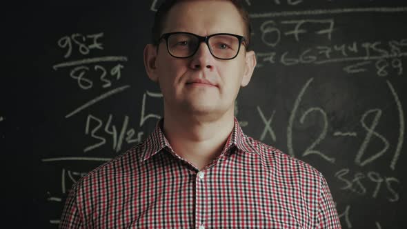 Man Writes Math Formula on Blackboard