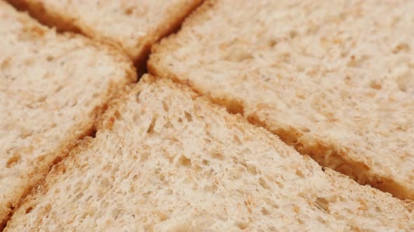 Fresh toast bread whole grain baked surface close-up slow tilt 4K 2160p 30fps UltraHD footage - Text alt