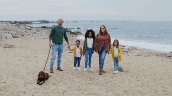Portrait of Happy Mixed Race Family On Beach