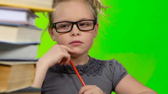 Girl Leafing Through a Book of Interesting Looks for Another. Green Screen. Close Up alt