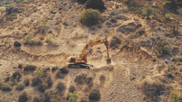 Yellow Dredger Digger Mine Excavate Rocky Ground in Countryside Mountain Area in Troodos alt