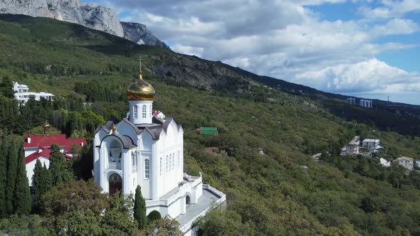 Aerial footage of a church in the mountains