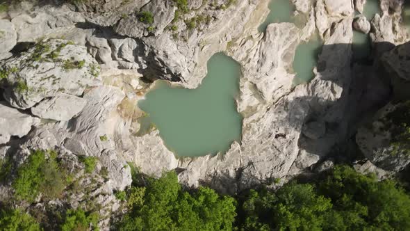 rotary motion drone headshot of Albanian canyon "Syri i ciklopit". Albanian nature stock videos. alt