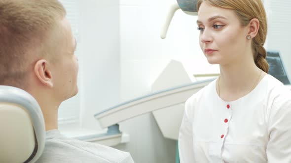 European Female Dentist Doctor Treats Patient Portrait