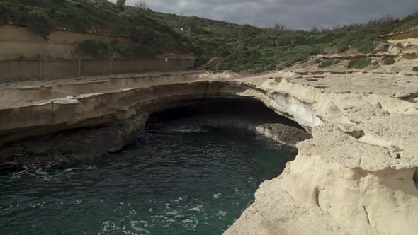 Cave of St Peters Pool on Cloudy Stormy Day with Black Clouds Forming in Sky alt