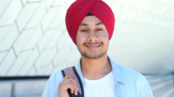 Modern Male Indian Student with Backpack Wearing Red National Turban