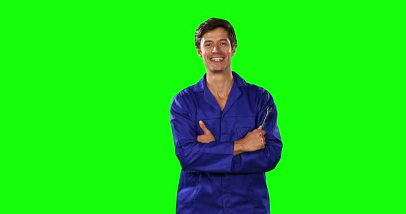 Front view of mechanic with green screen alt