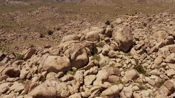 Aerial shot of interesting rock formations in the desert of California alt