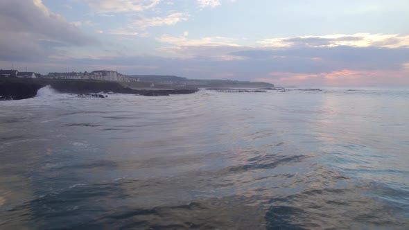 Ocean Waves Crashing Against the Rocky Shores of the Coastline alt