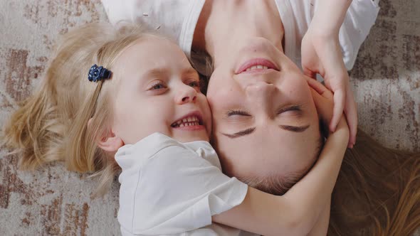 Top View Little Girl Daughter Child Kid Hugs Embraces Cuddles Beloved Adorable Young Blonde Mother alt