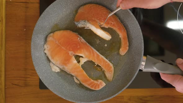 browning salmon steaks in no stick pan turning them alt