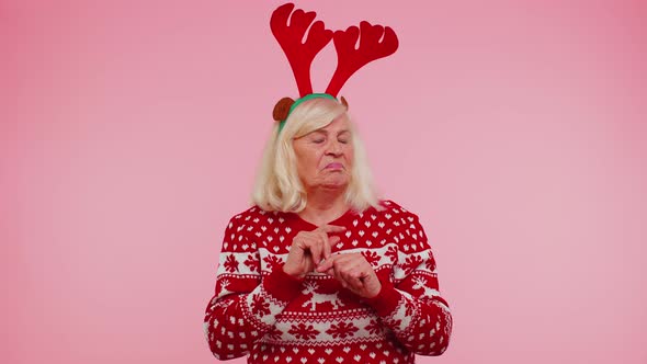 Angry Old Woman in Christmas Deer Antlers Raising Hands in Indignant Expression Quarreling Conflict alt