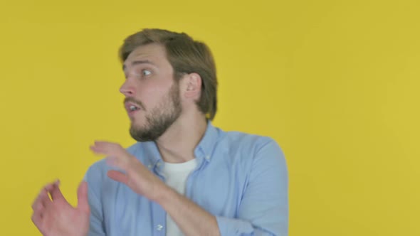 Young Businessman Feeling Scared Frightened on Yellow Background alt
