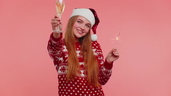 Lovely Girl in Christmas Santa Sweater Dancing with Bengal Sparklers Fireworks and Champagne Glass alt