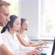 Diverse team of young professionals is working in the phone support office. - VideoHive Item for Sale
