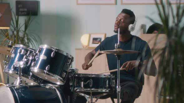 Black Musician Enjoying Drum Session alt