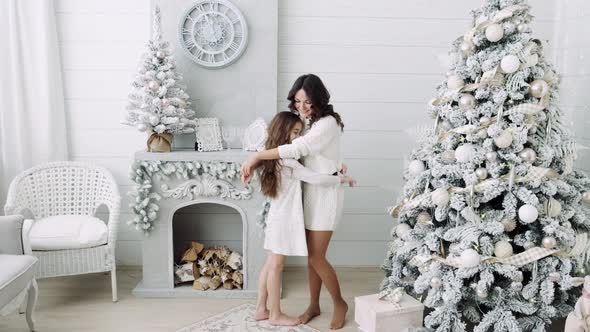Mom and Daughter on the Background of a Beautiful Christmas Interior. Family Mom and Daughter Next alt