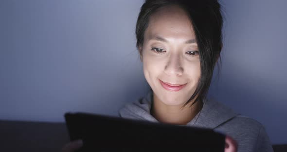 Woman use of tablet computer at night alt