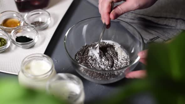Adding chia seeds into natural yogurt alt