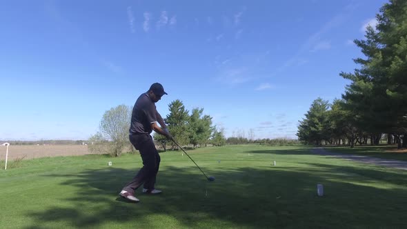 male golfer drives a ball far 4k alt