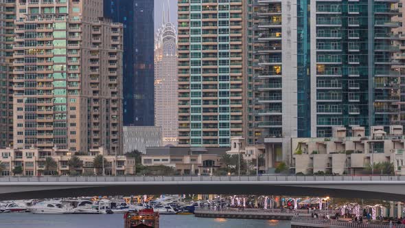 View of Dubai Marina Towers and Canal in Dubai Day to Night Timelapse alt