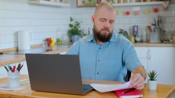 Beared Mature Man Doing Office Work at Home alt