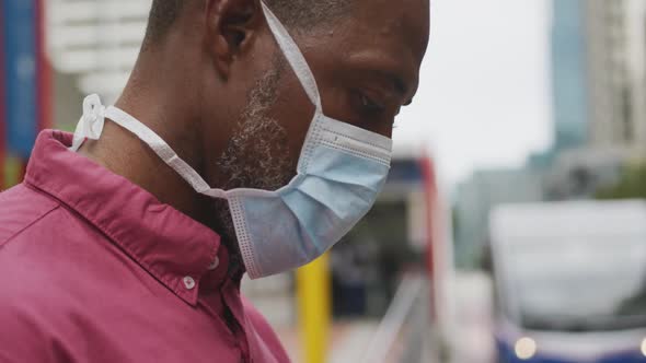 African american man on the go wearing coronavirus covid19 mask alt