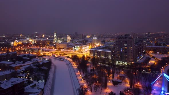 Evening illuminated Kharkiv city river aerial view