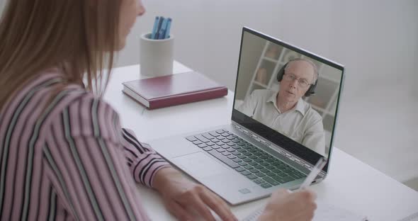 Student Is Making Notes of Online Lecture of University Professor, Communicating with Him By Video alt