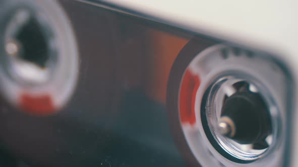Audio Cassette in the Tape Recorder Playing and Rotates. alt