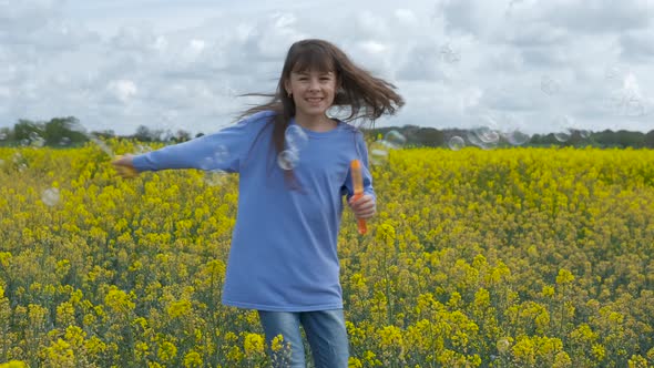 Happy child with soap bubbles. alt