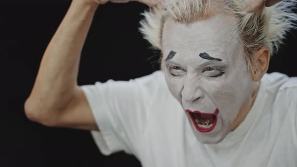 Mime Touches Tousled Hair Practicing Acting Before Show alt
