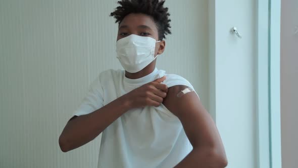 African American Teenager Showing COVID19 Vaccine Bandage Merrily alt