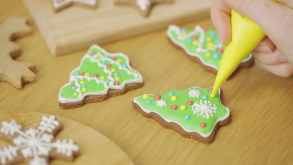 Close-up of a woman decorating a homemade gingerbread Christmas tree