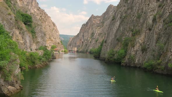 Unidentified Tourists Kayaking on the Lake Matka in Rocky Canyon alt