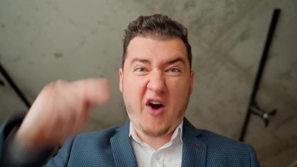 Male businessman screaming you fired looking at camera. Angry caucasian boss man express negative