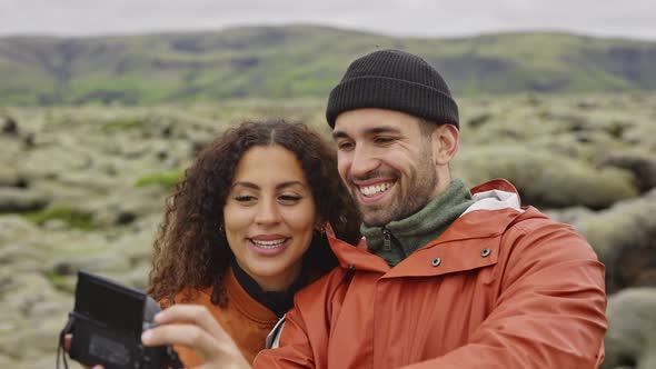 Smiling Happy Couple Posing For Selfie In Icelandic Landscape alt