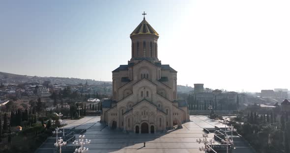Aerial view of Holy Trinity Cathedral Sameba in Tbilisi Georgia. Sunrise drone footage. alt