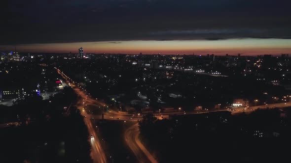 Aerial view of the streets of the city at night with Roundabout road junction 20 alt
